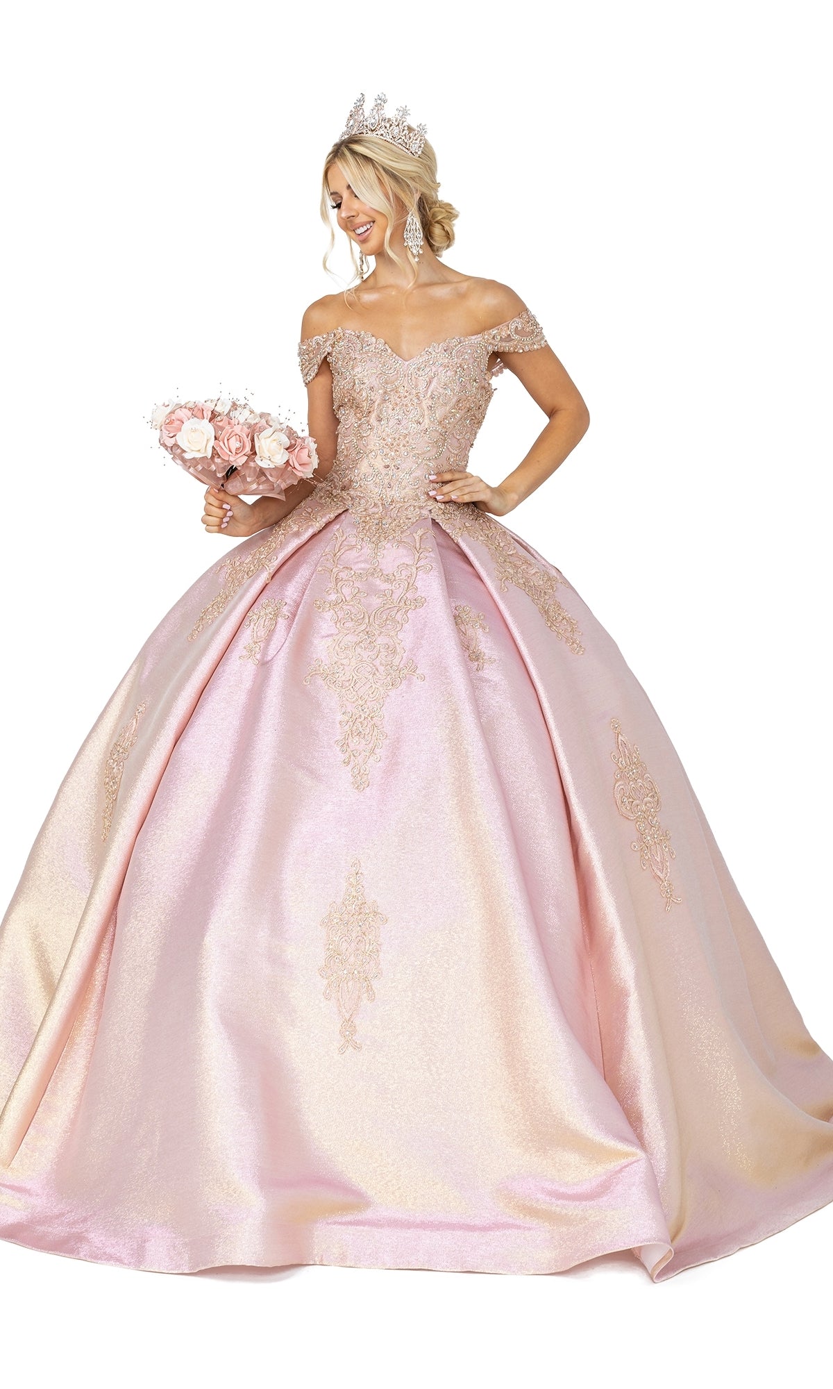A woman wears the Quinceanera Dress 1585 by Dancing Queen, a ball gown with a sweetheart neckline and gold embellishments, paired with a tiara, chandelier earrings, and holding a bouquet of pink roses.